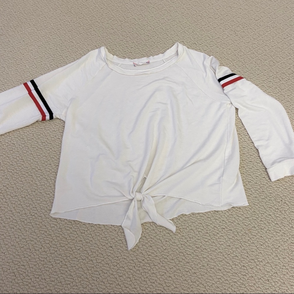 White sweater with red and navy stripes on sleeve